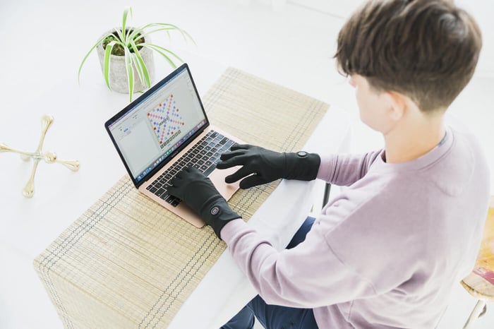 Typing on a laptop while wearing Toasty Touch heated gloves made by someone with Raynaud's