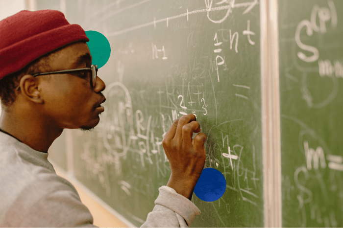 Do you have to take math in college? Student writing equations on a chalkboard.