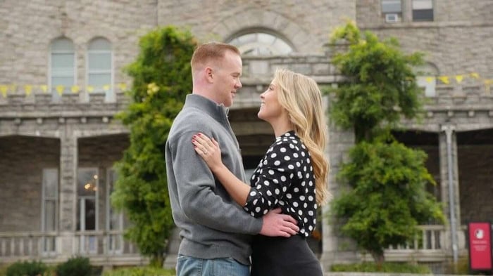 Ashley and Chad facing each other and smiling in from of Reid Castle