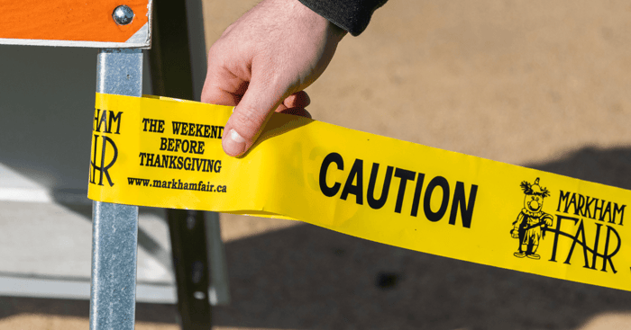 custom caution tape being attached to sign