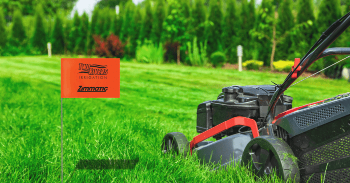 Irrigation flag in lawn being mowed