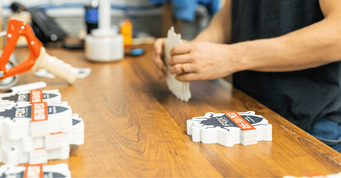 Blackburn employee stacking custom cut marking signs