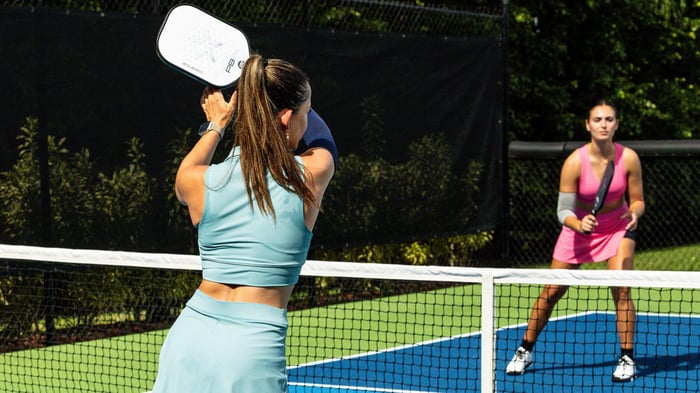 Two pickleball players in a competitive match
