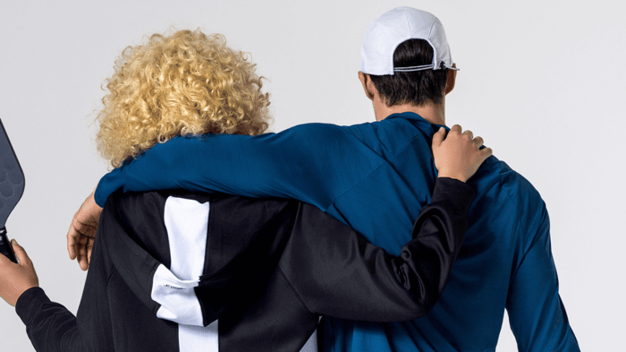 Pickleball players in apparel facing away