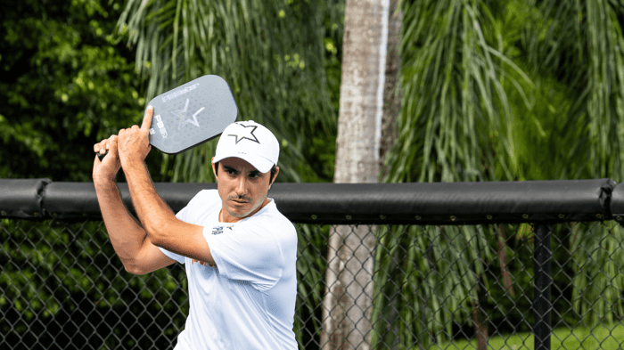Pickleball player swinging a paddle