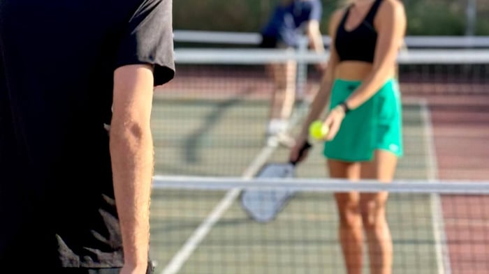 Close up shot of two players on a pickleball court