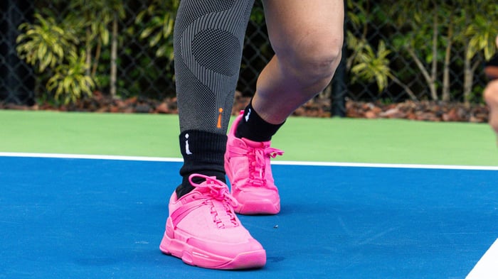 Close up shot of pink court shoes on a pickleball court
