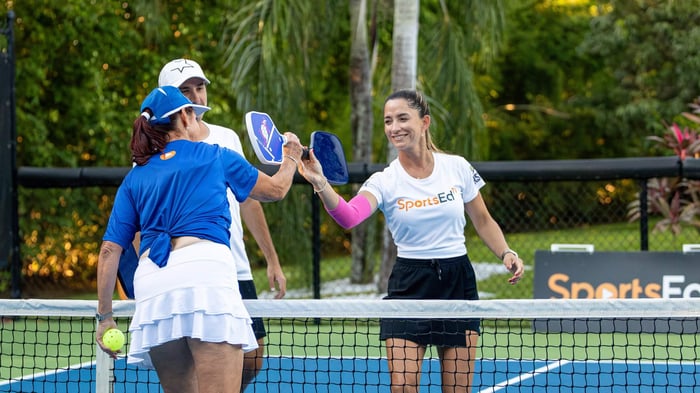 Two pickleball players greeting each other before a game