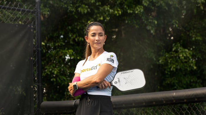 Woman pickleball player smiling on the court