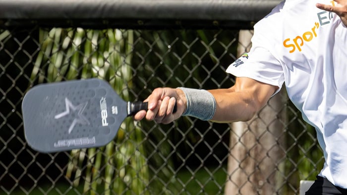 Close up of man returning a pickleball shot