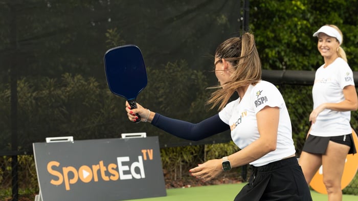 Two women playing doubles pickleball