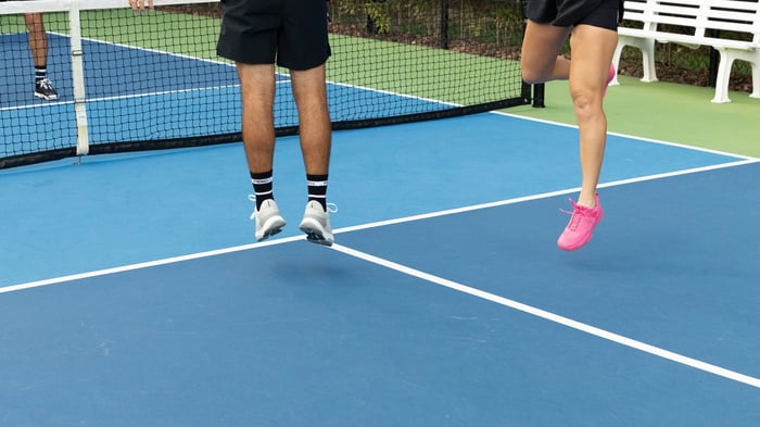 Shot of two players jumping on the pickleball court