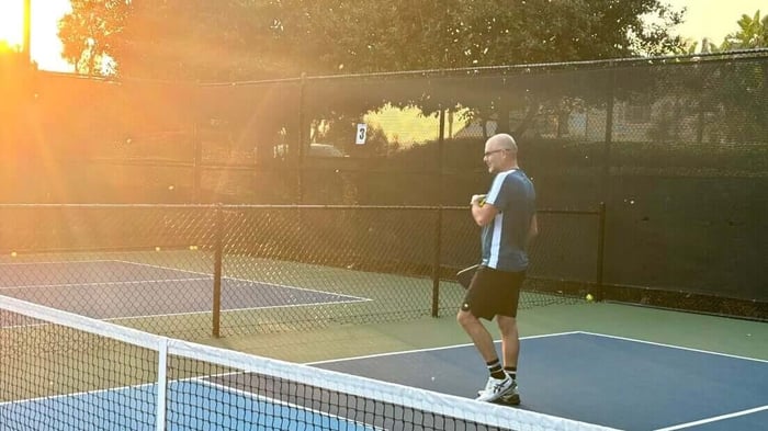 Man playing on a pickleball court during vacation