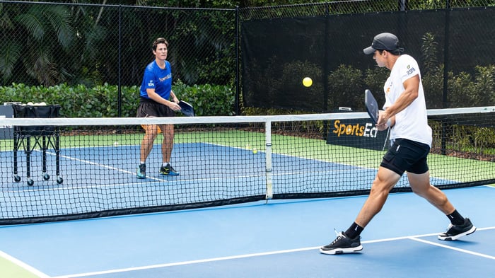 Two pickleball players in a game of pickleball