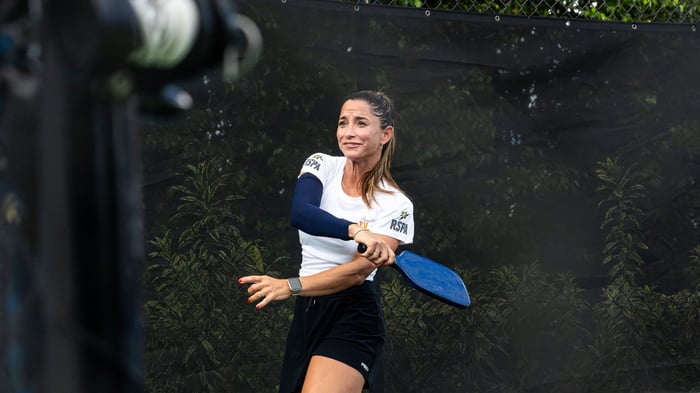 Woman returning a serve
