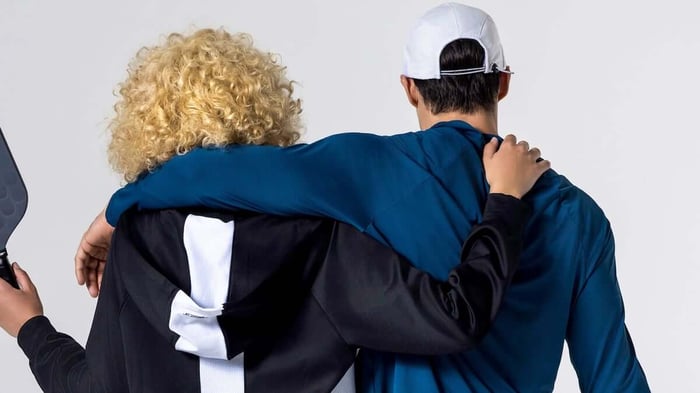 back shot of two pickleball players with their arms around each other