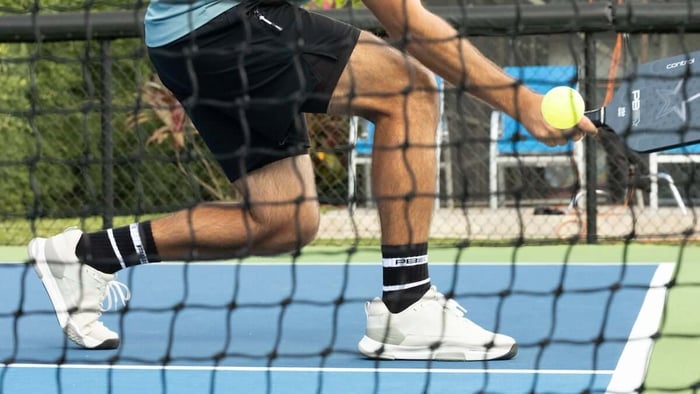 player about to hit the pickleball