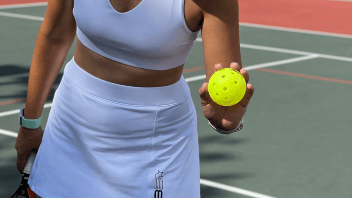 Picture of a woman holding a pickleball