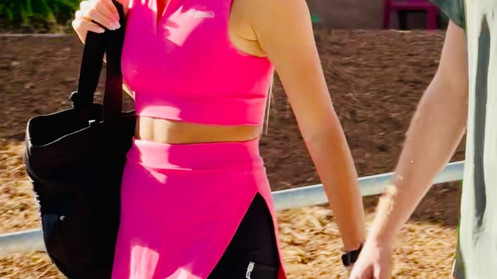 Pickleball player holding a black bag