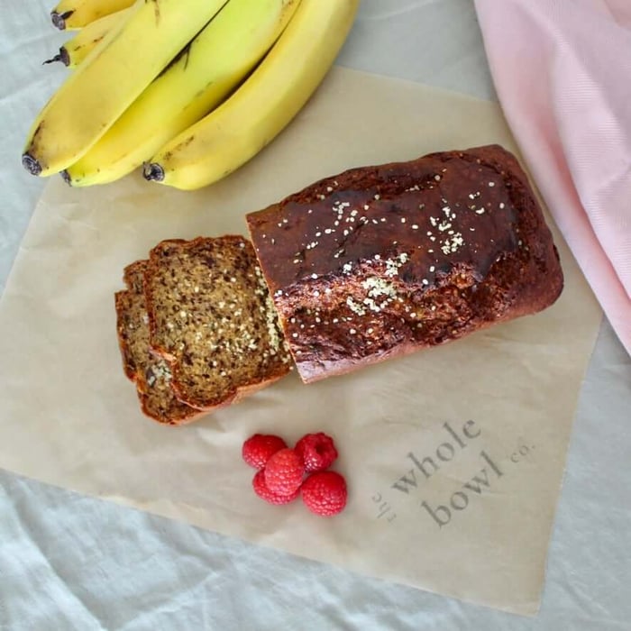 Wholesome banana bread sliced on wooden board – healthy and freezer-friendly recipe by The Whole Bowl Co.