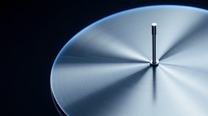 Quarter-wave monopole antenna mounted at the center of a circular metal ground plane disc with radial reflections under cool studio lighting