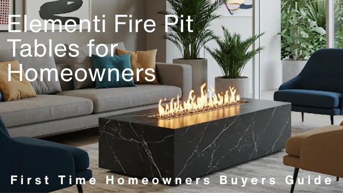 Elementi fire pit table in a stylish outdoor living room setting, featuring a rectangular black marble-like design with a lit flame, surrounded by a sofa and armchairs.