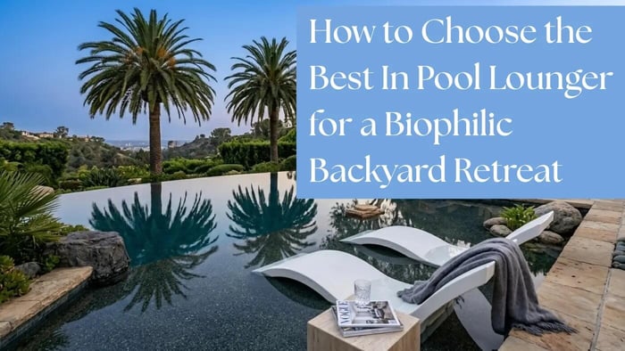 A commanding high-resolution photograph looking over a dark bottom infinity edge pool at a luxury Beverly Hills estate at dusk. Two white Ledge Lounger Signature chaises with a matte finish are submerged in a Pebble-Tec sun shelf surrounded by gnarle