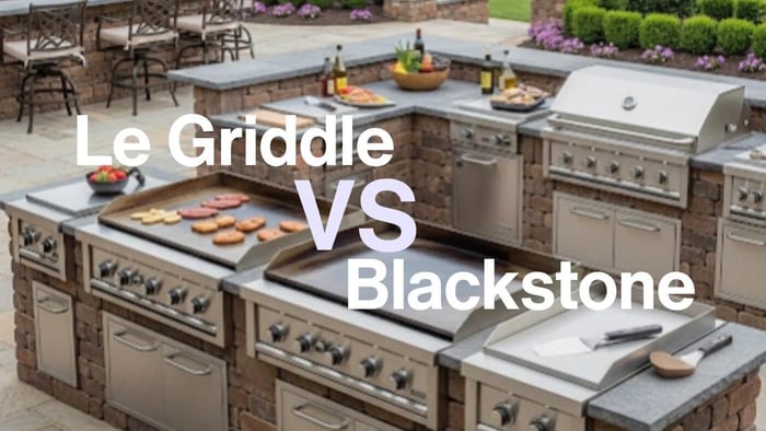 Two large, built-in outdoor kitchen islands are positioned side-by-side on a stone patio, surrounded by manicured landscaping and outdoor seating. On the left island, a 