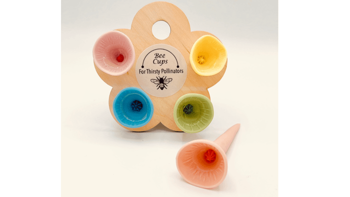 Close-up of colorful porcelain Bee Cups designed to provide safe hydration for bees and pollinators.