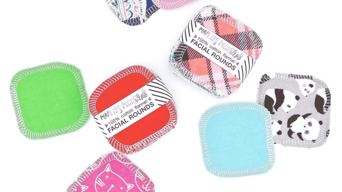 A collection of Marley's Monsters earth friendly products, including unpaper towels, reusable sponges, and facial rounds.