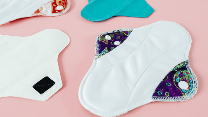 Comparison of reusable menstrual pads and disposable pads with eco-friendly options from Mudd House Mercantile