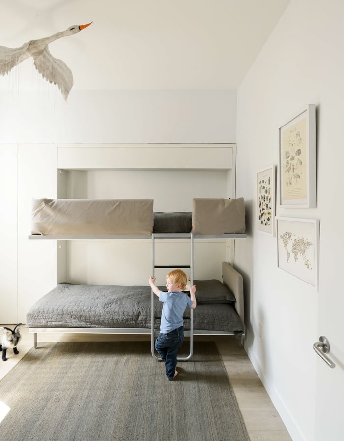 Child using the Kali Duo bunk bed from Resource Furniture.