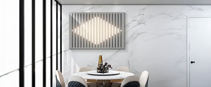 Contemporary dining room with geometric light-panel wall art and a minimalist round dining table.