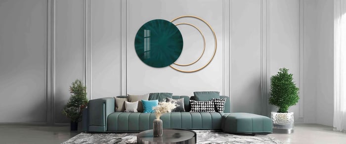 Abstract living room 3D Art with teal and gold circles, creating a striking visual effect on the wall, displayed above a modern teal sofa with patterned pillows and sleek décor