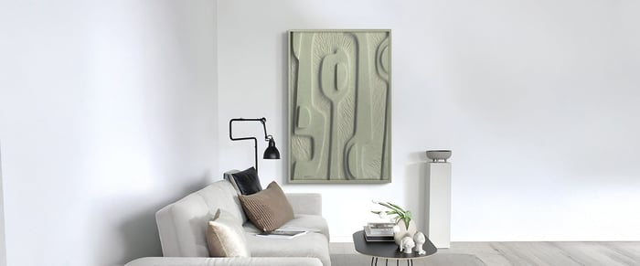 Organic panel wall art in beige tones above a minimalist white sofa with taupe pillows in a bright modern living room.
