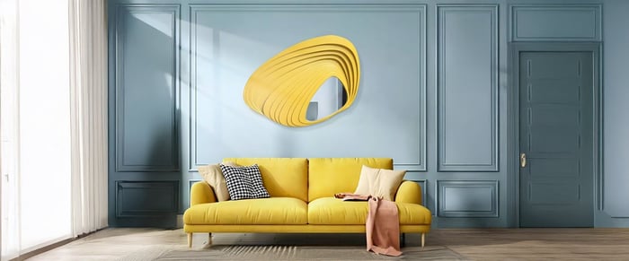 Modern blue wall with abstract yellow 3D wood art above a matching yellow sofa, adding bold contrast and artistic flair.