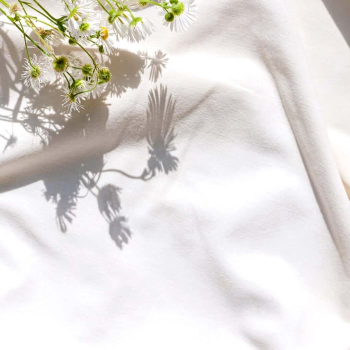 GOTS certified organic cotton sheets folded in natural light