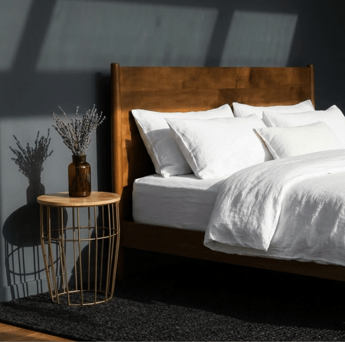 organic wool comforter on bed with soft white bedding, naturally hypoallergenic and breathable