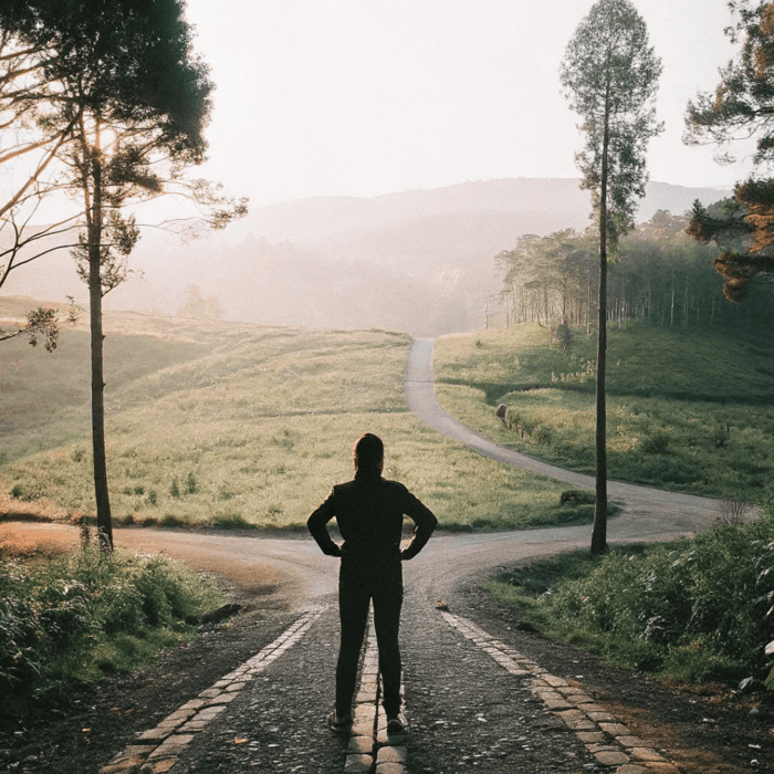 A person stands in a fork in the road, ready. Embrace your true calling