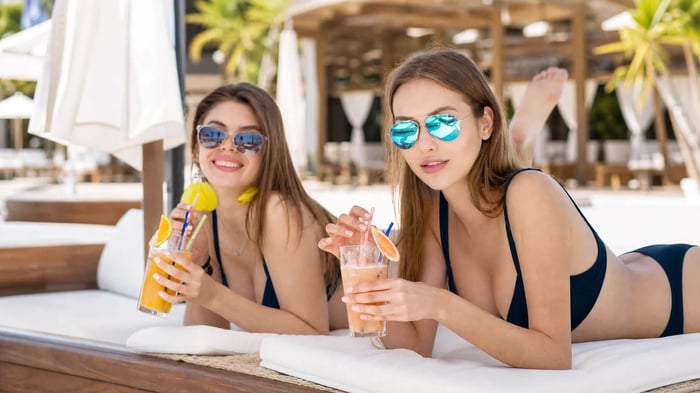 Young woman in a bikini model bikini — a floral triangle top with bow detail — posing confidently at a vibrant outdoor market
