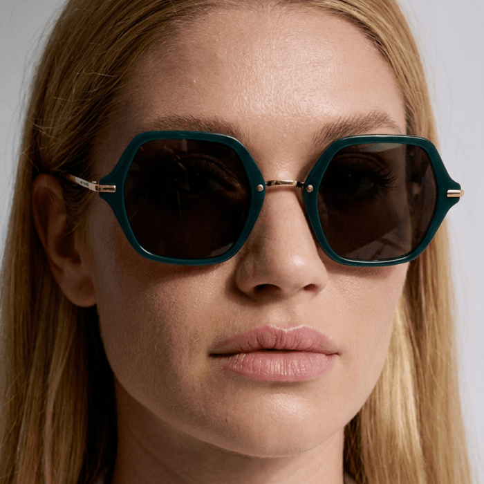 Are polarized sunglasses worth it luxury teal octagon sunglasses with dark lenses on a woman with clear skin and natural makeup highlighting glare reduction eye protection and elevated everyday style
