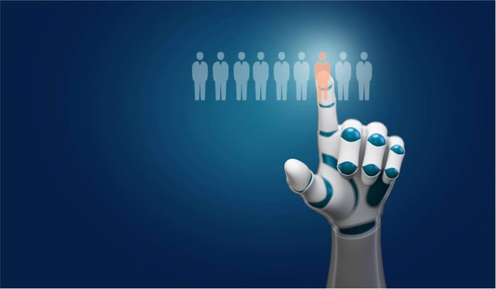 A futuristic image showing a robot analyzing data on a screen while a human recruiter shakes hands with a candidate, illustrating the ideal partnership in AI hiring