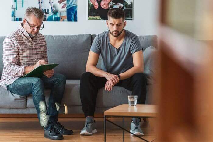 A man reflecting in a calm space, representing the importance of men's mental health and emotional well-being