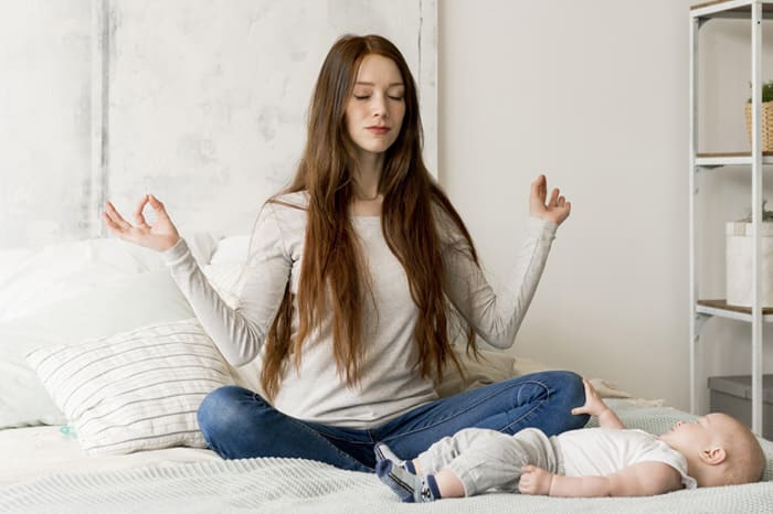 A new mother practicing relaxation techniques to manage postpartum anxiety and regain peace of mind.