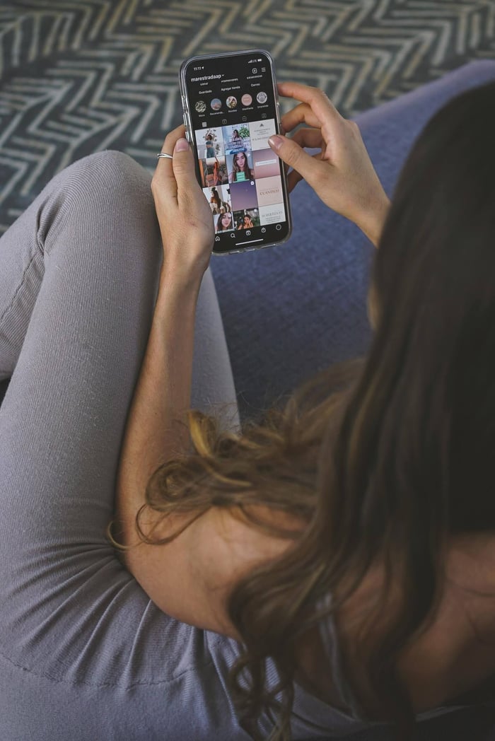 mother scrolling social media and feeling self-critical
