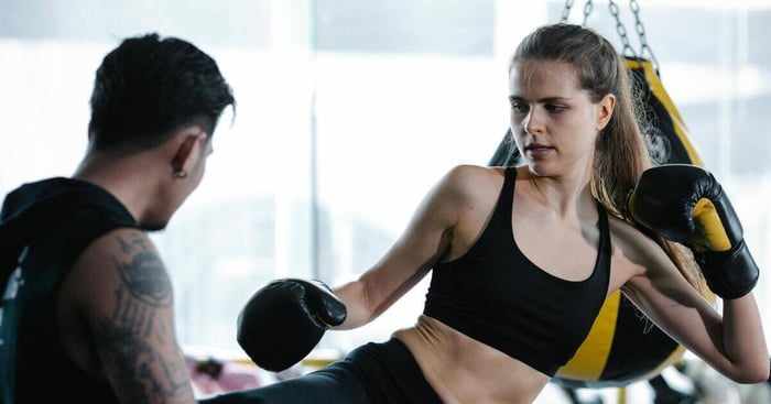 Woman boxing with personal trainer