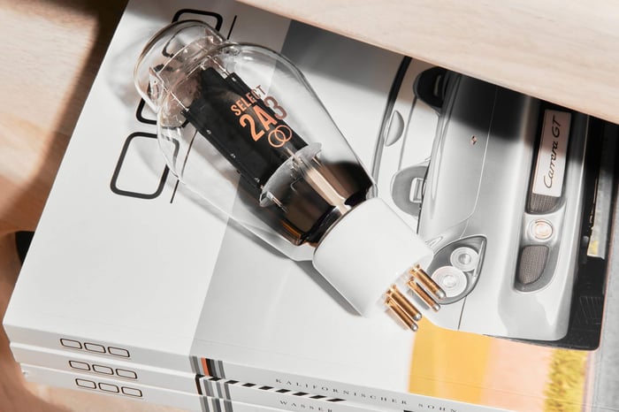 A hand-selected Ray Tubes SELECT 2A3 vacuum tube displayed on a stack of automotive magazines.