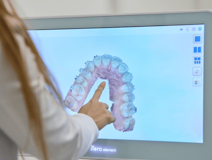 A woman pointing to a monitor