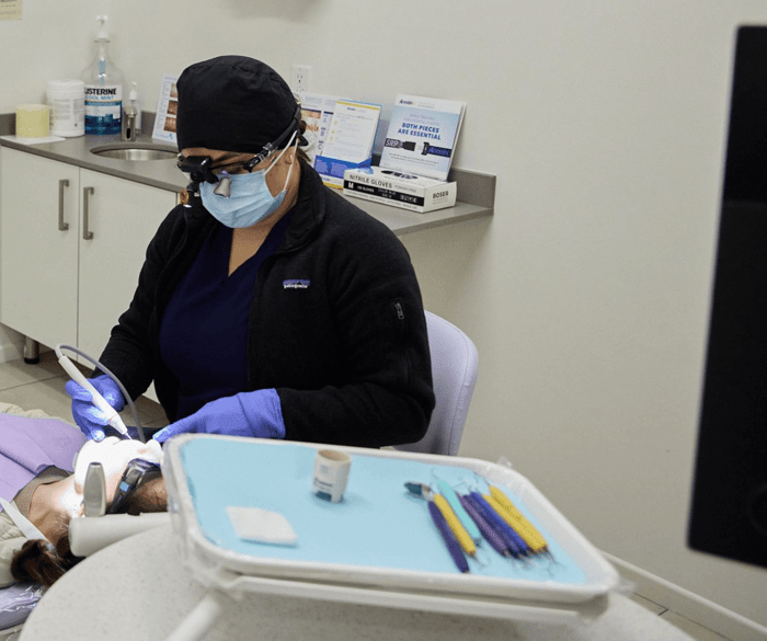 A dentist working on a patient