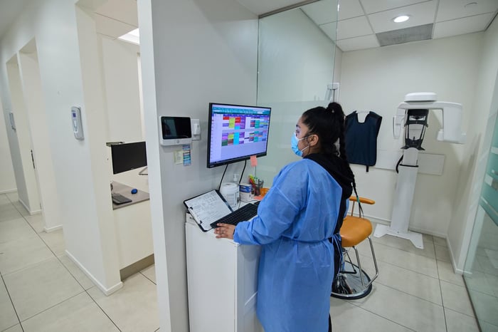 A woman looking at a screen wearing a blue robe